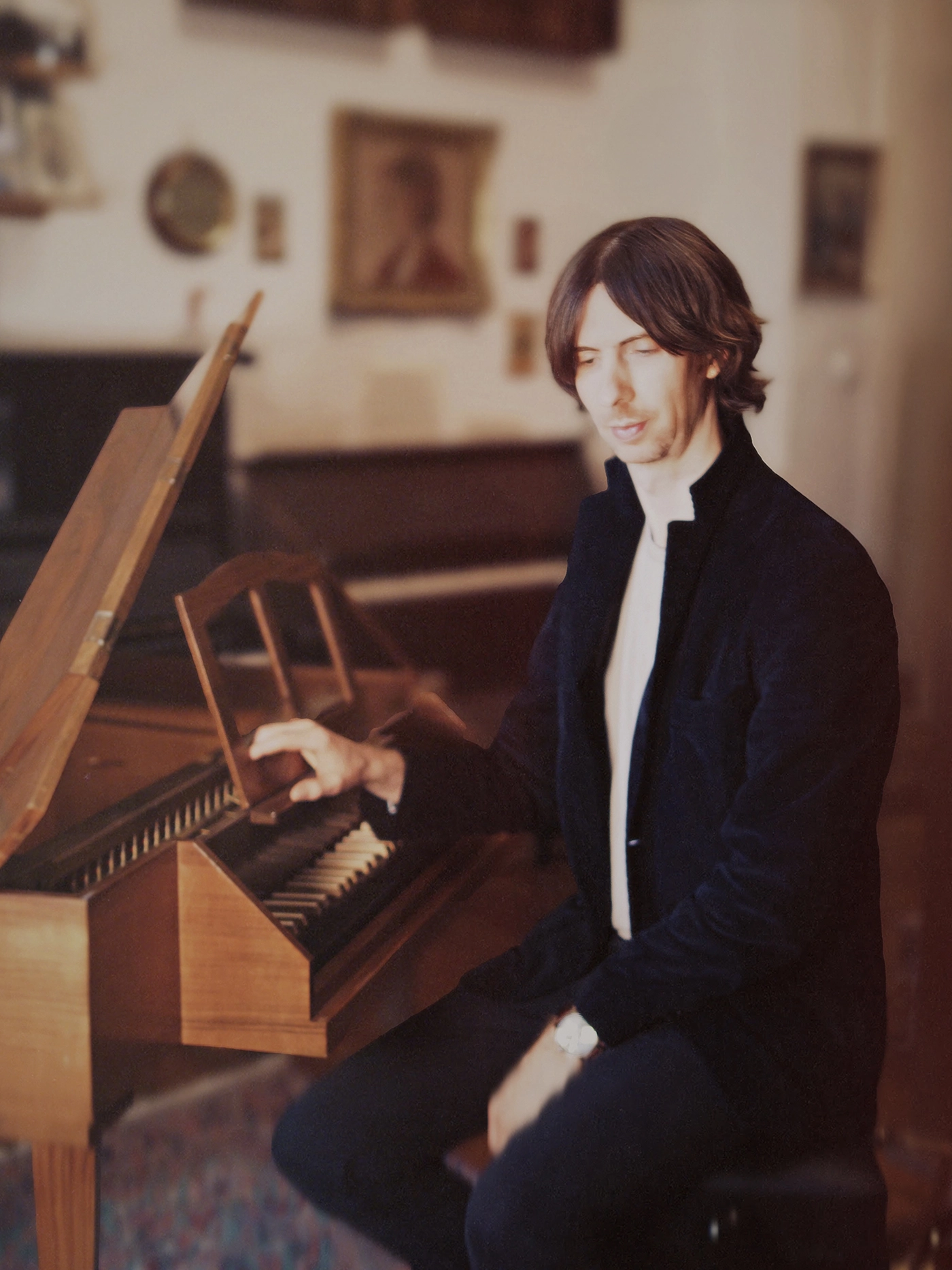 Composer Oskar Schuster with his spinet harpsichord